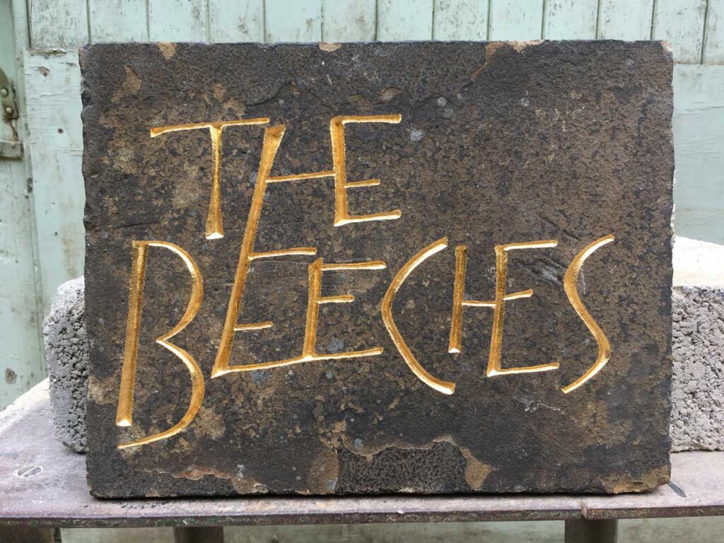 Stone house name and number plaques and hand carved sandstone signs